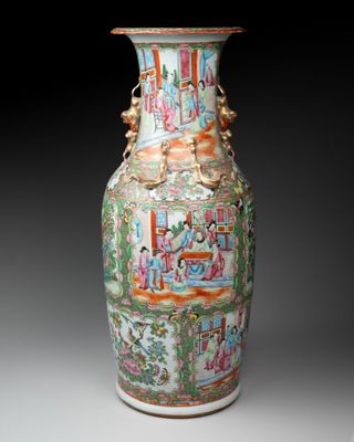 a vase with a painting on it sitting on a table