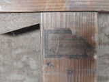 a sign on the door of an old wooden building