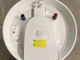 a white toilet with a yellow sticker on it