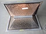 a metal box with a label on it sitting on the floor