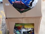 a cardboard cart with a lot of items inside of it