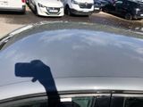 a shadow of a person on the roof of a car