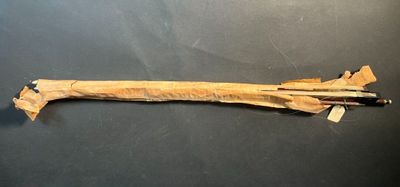 a wooden stick with a knife on it on a table