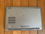 a laptop that is sitting on a wooden floor