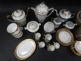 many different types of porcelain dishes and cups on the table