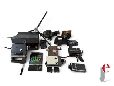 a lot of old cameras and other electronics on a white surface