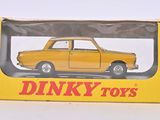 une petite voiture jaune dans une boîte jaune posée sur une surface blanche