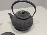a tea pot and a tea pot sitting on a table