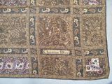 a close up of a patchwork cloth with a name on it