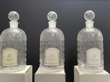 three glass bottles that are sitting on top of each other
