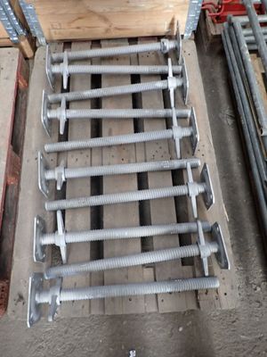 a wooden pallet that has a bunch of bolts on it