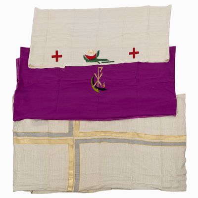 a close up of a purple and white cloth with a cross on it