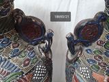 two vases that are decorated with colorful designs on them