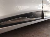 a close up of a car door handle and the door handle of the car