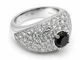a close up of a ring with a black stone surrounded by white diamonds