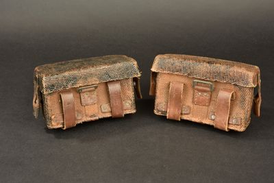 pair of antique leather luggage bags on a black background