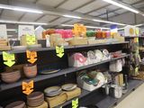 many plates and bowls on the shelves in the store