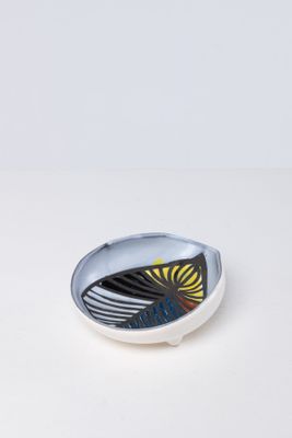 an image of a plate with a bird on it on a white surface