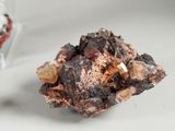 a small piece of rock that is next to a glass