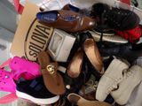 many pairs of shoes in a box on the floor