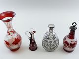 three glass vases sitting next to each other on a white surface