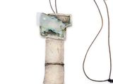 a necklace that has a picture on it on a cord