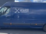 a blue van parked in front of a building