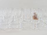 many empty wine glasses lined up on a white surface