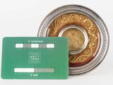 a credit card sitting next to a coin on a table