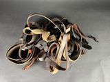 a pile of old leather shoes on a gray surface