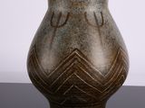 a vase that has a design on it on a table
