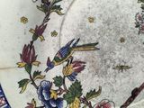an image of a plate with a bird and flowers on it