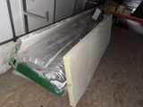 a white refrigerator sitting in the middle of a room under construction