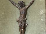 a statue of jesus on the cross on a green cloth