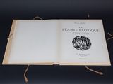 an open book sitting on top of a table on a black surface