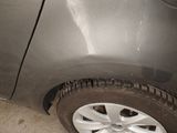 a close up of a car ' s tire on the side of the road