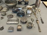 a table with a lot of silver items on it