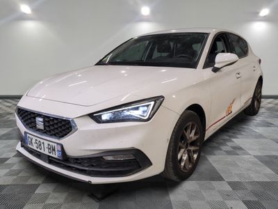 the white car is parked on a checkered floor in the garage