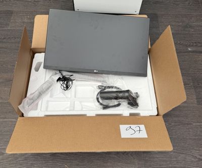 a box with a laptop in it sitting on the floor