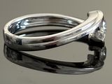 a close up of a ring with a diamond on it