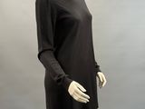 an image of a mannequin wearing a black dress on a mannequin stand