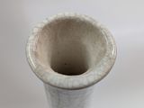 a white vase with a cracky design on it