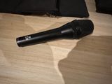 a microphone sitting on the floor next to a bag