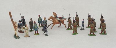 many figurines of different types of soldiers on a white surface