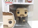 a close up of a pop vinyl figure of a man in a suit
