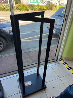 a person sitting at a table with a cell phone in front of a window