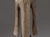 l'image d'une statue en bois représentant un homme avec un chapeau sur la tête