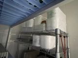 many rolls of toilet paper on the shelves in the kitchen