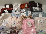a lot of shirts that are sitting on a table