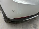 a close up of a car ' s rear bumper with a hole in it